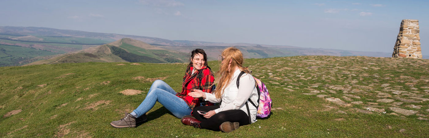 Two students sat at the top of Mam Tor in the High Peak