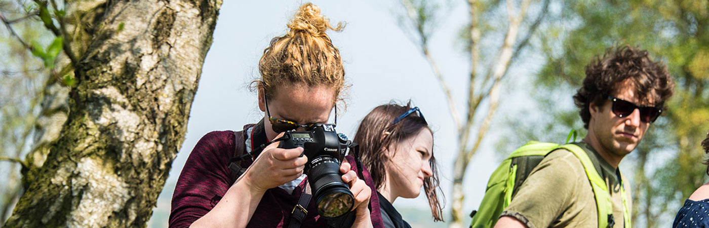 Female student taking photo with professional camera